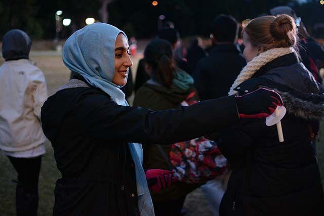Hanan Budwan, a freshman studying business administration hands out candles to people who attend the vigil. The 'Our Three Winners' memorial took place on Feb 10, 2016 at Stafford Commons, outside Talley Student Union. The memorial was centered on sharing the story of Deah, Yusor and Razan and all the things they have done for our community.