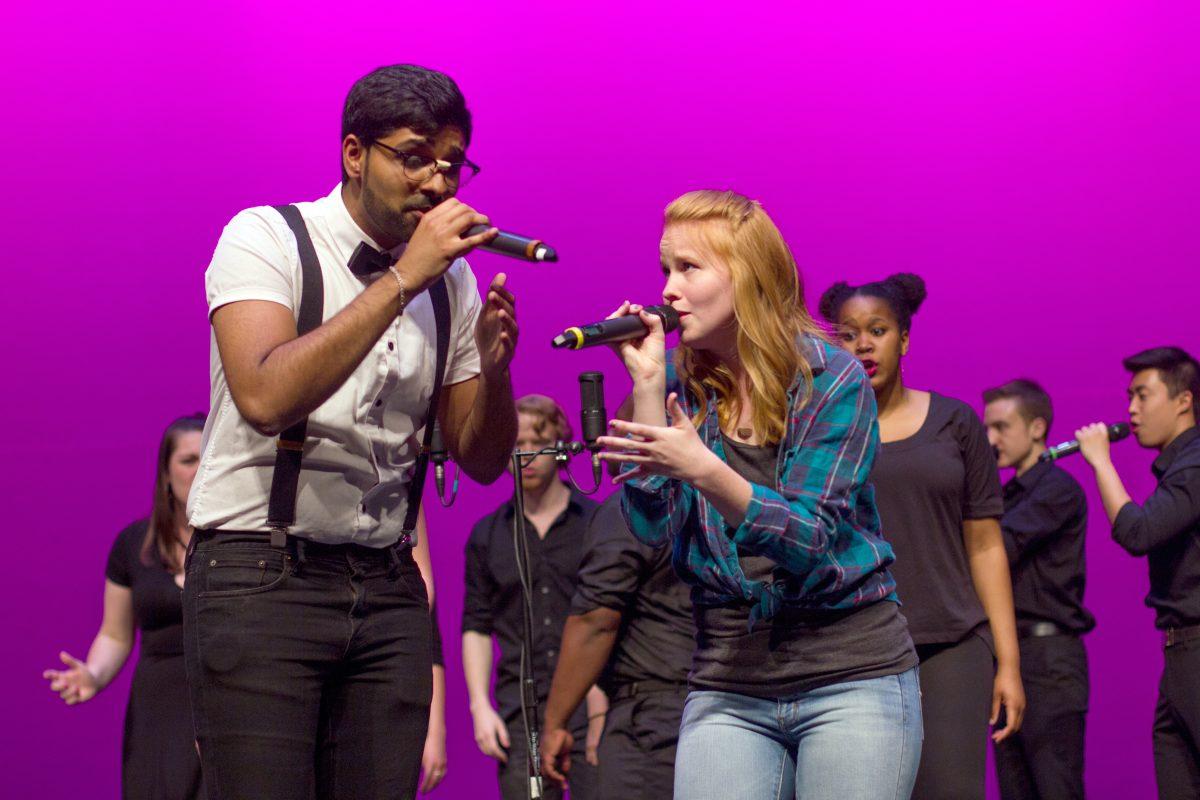 Acappology Music Director Shaunak Turaga, a senior studying electrical and computer engineering, sings a duet with Anna Griffin, a senior studying religious studies, at Accapology's Spring Concert at Stewart Theater on March 30, 2016. The concert, called "Writing is Hard: Stories through Song", is the group's annual concert in which they honor their graduating seniors as well as invite alumni of the group for a performance to close the show.