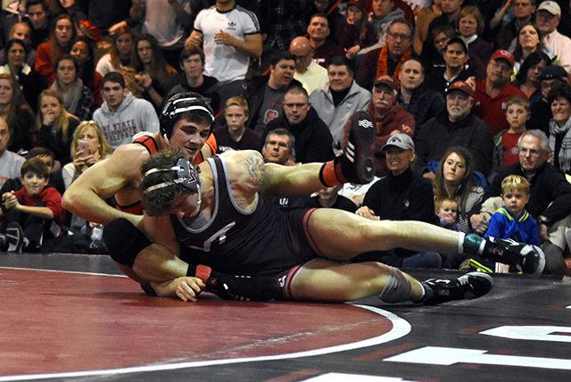 Junior Pete Renda fights for position on the ground during his match against Virginia Tech during the Hokie-Wolfpack dual meet. By the final match, the Hokies came out on top by a score of 19-14, snapping the Wolfpack's undefeated streak in the Holshouser Building Feb 12.