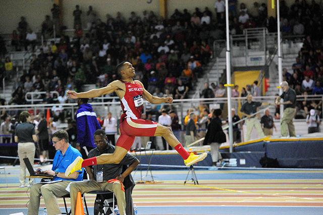 Senior Johnathan Addison leaps across the field at the Indoor Nationals. Addison placed second in the long jump, earning eight points for his team and helping the men's track and field team finish 14th at the NCAAs.