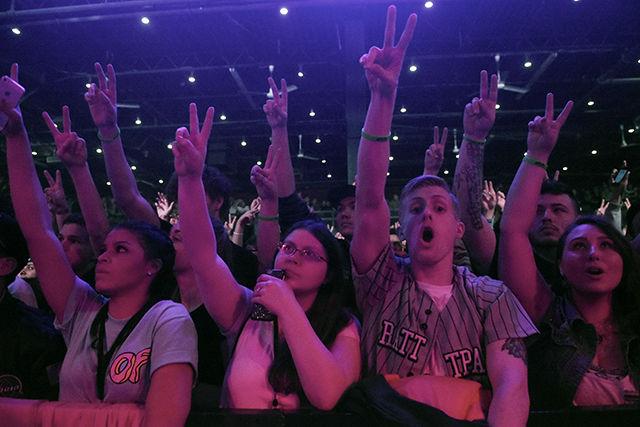 Fans in the crowd throw up the peace sign during Dj Rhetorik's on March 19th to during The Incredible World Tour.
