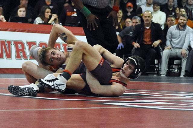 Redshirt freshman Sean Fausz grapples for ground position in his match against Virginia Tech. The meet, which was held in the Holshouse building, was won by the Hokies Feb. 12.