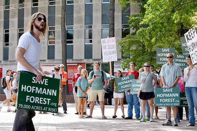 N.C. State alumnus with degrees in environmental science and political science Andrew Payne delivers a powerful message to a group of peaceful protesters holding signs in the Brickyard against the sale of Hofmann Forest at lunchtime Monday. Payne's message was that we need to stop the sale of Hofmann Forest and go through a more transparent process to determine its fate. He encouraged everyone to e-mail the dean and chancellor in order to express their anger and frustration about the process.
