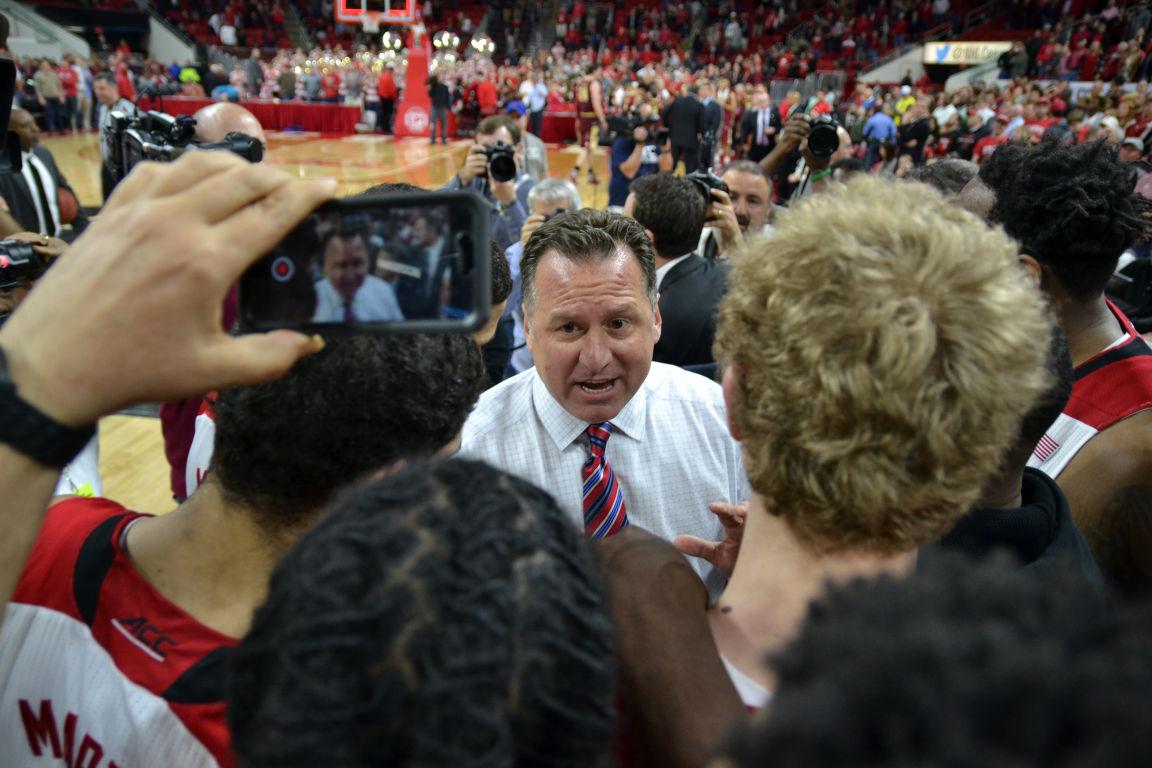 NC State basketball coach Matt Gottfried talks to his team's members after the final buzzer while they wait to hear if freshman forward Maverick Rowan's last shot made it in time to win the game on Wednesday, March 2, 2016, at PNC Arena.