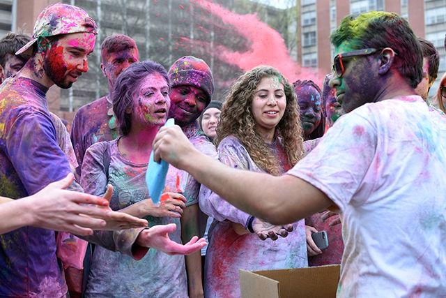 Members of Ektaa, a south Asian student group on campus, hand out packets of colored powder for Holi, an Indian festival filled with colors. This event was cohosted by Maitri, Ektaa, UAB and Kappa Phi Lambda and took place on March 19, 2016 on Lee Field.