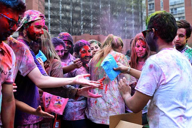 Members of Ektaa, a south Asian student group on campus, hand out packets of colored powder for Holi, an Indian festival filled with colors. This event was cohosted by Maitri, Ektaa, UAB and Kappa Phi Lambda and took place on March 19, 2016 on Lee Field.
