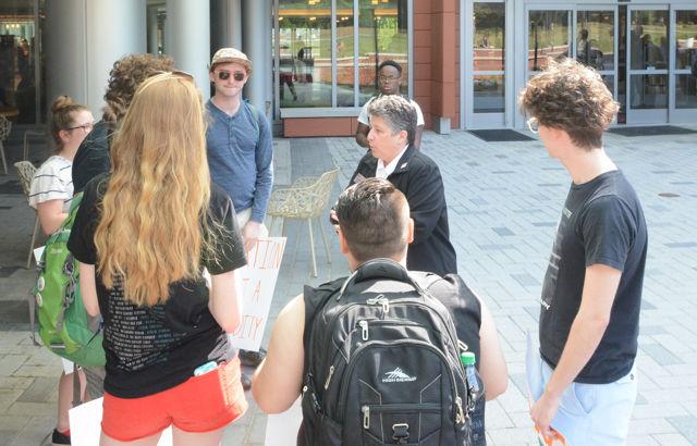 Justine Hollingshead, chief of staff for the Vice Chancellor and Dean, talks to students gathereed to protest Margaret Spellings's visit to NC State's campus on Wednesday, April 20th. Protesters gathered on Stafford Commons and then in the lobby of Talley Student Union to show their opposition to Spellings, who has expressed beliefs that many Noth Carolina public univeristy system students disagree with, taking the position of president of the UNC public university system.
