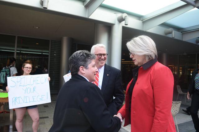 Maragaret Spellings, former secretary of education and current president of the UNC System, greets Justine Hollingshead, Chief of Staff, in Stafford Commons as she approaches a crowd of student protestors on April 20, 2016.