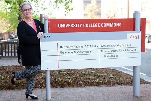Miss Mindy Sopher, academic advisor and lecturer, stands beside the sign in front of University College Commons in her dancing shoes on Wednesday, March 30. Sopher will be participating in the "Dancing Like the Stars" competition at the Southern Women's Show being held at the State Fairgrounds in Raleigh on April 23rd. The competition will benefit the National Inclusion Project, a non-profit organization dedicated to inclusion of children with disabilities.