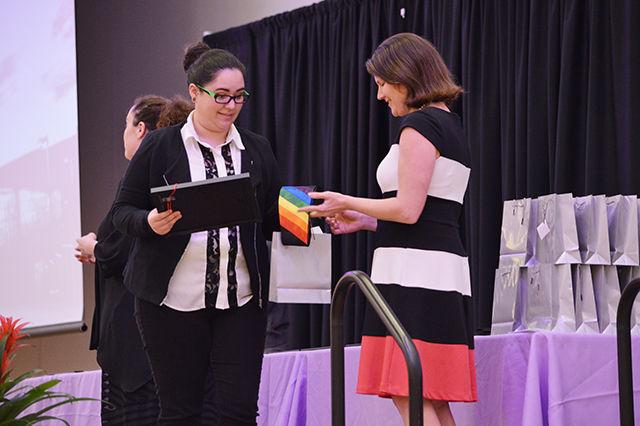 Zane Burns, a senior studying biochemisty and minoring geology, accepts their award and "Swag Bag" during Lavender Graduation in Mountains Ballroom on Tuesday, April 19, 2016. Lavender Graduation is an annual ceremony that honors lesbian, gay, bisexual, transgender, and ally students and honors their achievements and contributions to the university. Lavender Graduation began in 1995 at the University of Michigan by Dr. Ronni Sanlo.