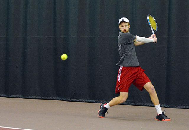 Simon Norenius, a senior, returns a South Carolina serve during his singles match Feb. 7. He went on to win his match, which was held in J.W. Isenhower Tennis Center.