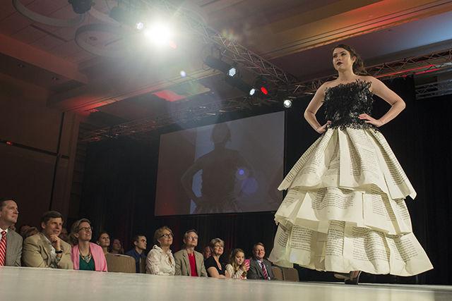 Erin Roberts, a senior studying textile technology management, models a dress by Bethany Faulkner at Art2Wear 2015 April 17 in the Talley Student Union State Ballroom. Roberts was one of dozens of student models who showcased the work of nine student designers within the Colleges of Design or Textiles.