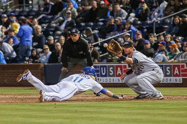 Shortstop Taylor Motter dives back to first to prevent an out. Motter had two hits on five at bats during the 7-3 win over Charlotte on April 7th in the Durham Bulls Athletic Park.