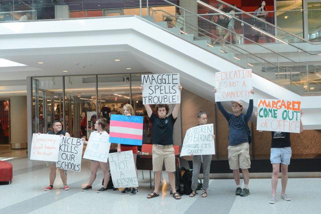 Various NC State students hold signs in silence to protest Margaret Spellings's visit to NC State's campus on Wednesday, April 20th. Protesters gathered on Stafford Commons and then in the lobby of Talley Student Union to show their opposition to Spellings taking the position of president of the UNC public university system.