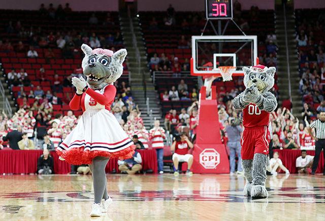 Ms. Wuf and Mr. Wuf dance during a break in the game while the cheerleaders pump up the fans during the 76-73 buzzer-beating thriller over High Point University in PNC Arena on Dec. 16.