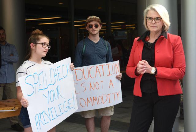Maragaret Spellings, former secretary of education and current president of the UNC System, speaks with Hannah Fennell, speaks with student protesting her appointment as president during her visit to North Carolina State University in Stafford Commons on April 20, 2016.