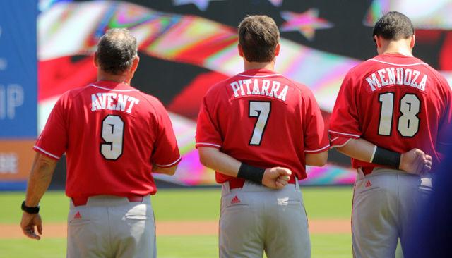 Head coach Elliott Avent, sophomore infielder Stephen Pitarra and sophomore infielder Evan Mendoza rise for the national anthem at the first round ACC Baseball Tournament game at Durham Bulls Athletic Park on May 25.The wolfpack lost to Florida State 7-3.