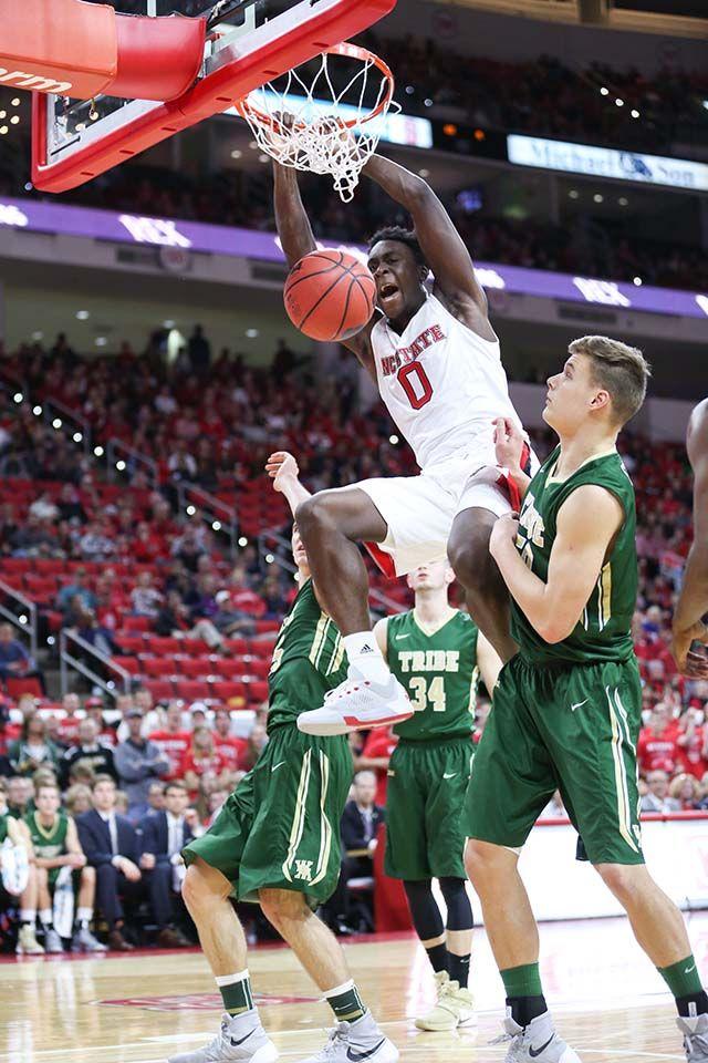 Sophomore forward Abdul-Malik Abu slams the ball for a dunk against two Tribe defenders. Abu finished the game with 17 points on 8-for-16 shooting, six rebounds and four assists in 30 minutes of gameplay. The NC State men's basketball team was destroyed by William &amp; Mary, 85-68, in the season opener on Nov. 13 to fall to 0-1 on the season at PNC Arena.
