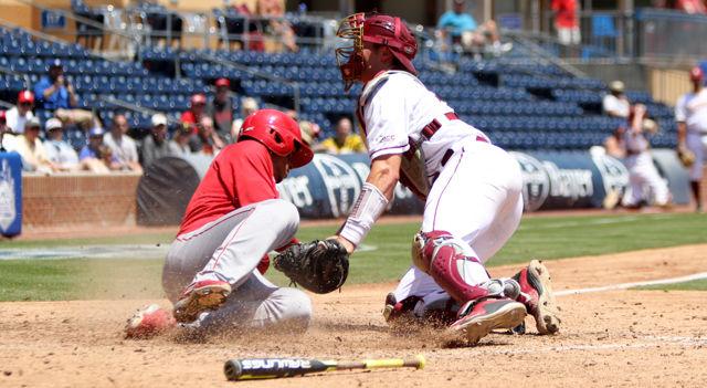 Sophomore infielder Joe Dunand slides home during the first round ACC Baseball Tournament game at Durham Bulls Athletic Park on May 25. Dunand scored one run and had one hit in three at bats. The wolfpack lost to Florida State 7-3.