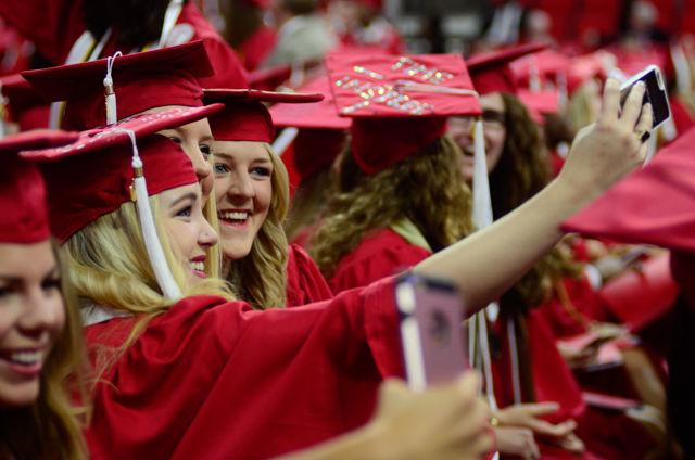 Three undergraduate students pose for a post-graduation selfie on May 7, 2016 in PNC Arena during the 2016 spring commencement. During the 2016 spring commencement 5,596 undergraduate degrees were awarded. The commencement also featured an address from Adm. Michelle Howard, the Navy's first female four-star admiral, a musical interlude by the Ladies in Red and a student address by Tatiana DeBerry, a graduating senior in criminology.