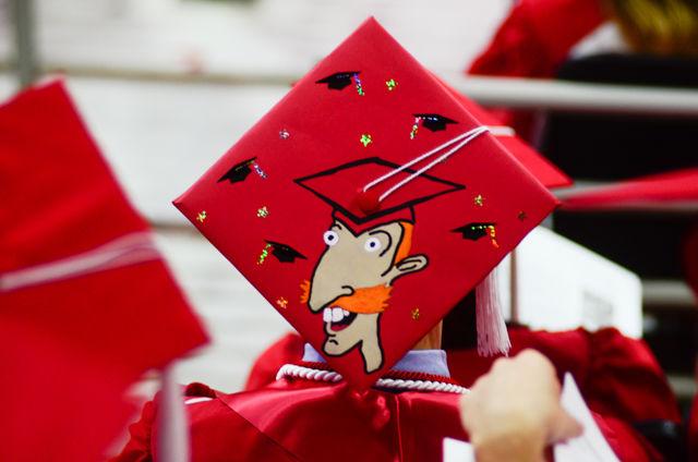 A "Nigel Thornberry" decorated cap sits on a graduate&#8217;s head on May 7, 2016 in PNC Arena during the 2016 Commencement Ceremony.