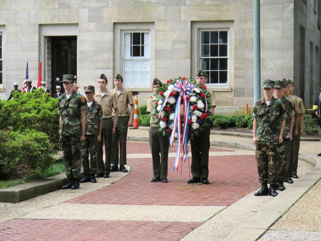 Young cadets present the wreath to honor those who have died serving in the military on Monday in front of the Capitol building. The wreath was donated by Forest Hills Florist and will stay on display in the Capitol.