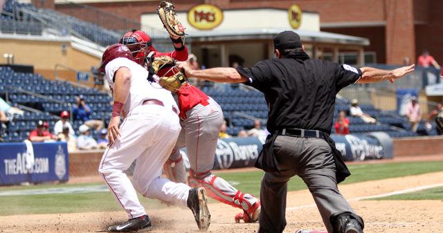 Junior catcher Andrew Knizner misses the tag on a runner sliding into home during the first round of the ACC Baseball Championship against Florida State on May 25, 2016. The Wolfpack lost 7-3 at Durham Bulls Athletic Park.