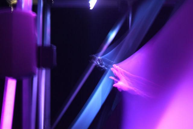 An attendee of Moogfest makes music in Grimes's "REALiTi" interactive art instillation. Participants interacted with mesh which distorted the song REALiTi creating something new.