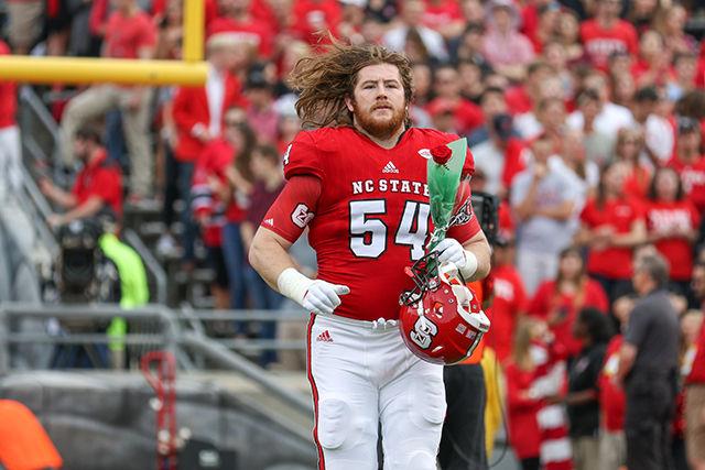 Joe Thuney walks onto the field for Senior Day before the game against the Tar Heels on November 28, 2015 at Carter-Finley Stadium.