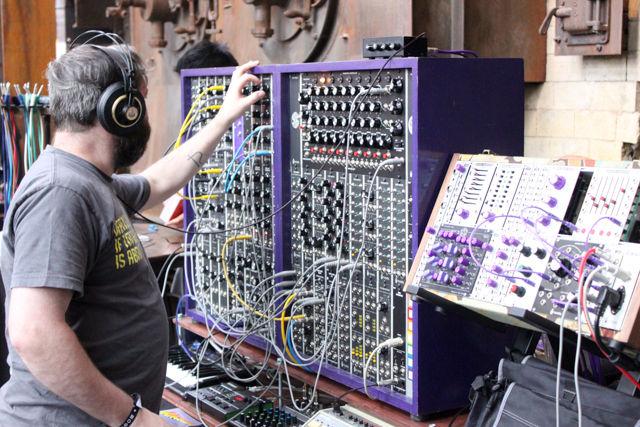 An attendee of Moogfest makes music on a synthesizer in the Modular Marketplace Thursday May 19. Modular Marketplace was a free, interactive exhibit set up in The Boiler Room at the Power Plant where participants could play with, test-drive, and experience the next generation of musical devices and meet their designers.