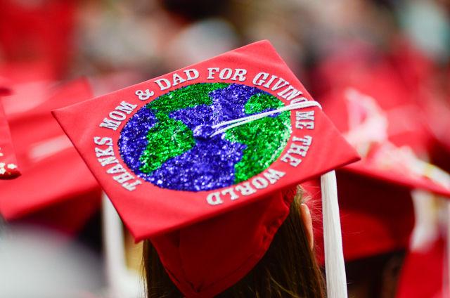 A "Thanks mom &amp; dad for giving me the world" decorated cap sits on a graduate&#8217;s head on May 7, 2016 in PNC Arena during the 2016 Commencement Ceremony.