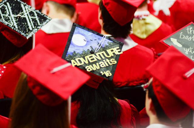 An "Adventure awaits" decorated cap sits on a graduate&#8217;s head on May 7, 2016 in PNC Arena during the 2016 Commencement Ceremony.