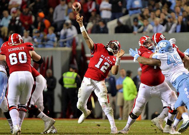 Redshirt senior quarterback Jacoby Brissett hurls a pass downfield against the Tarheels at Carter Finley Stadium on November 28. The Wolfpack fell to the Tarheels 45-34.