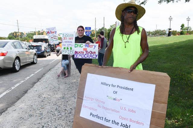 Ray James, Raleigh business owner, protests Hillary Clinton at the end of her rally held on the corner of Hillsborough Street and Blue Ridge Road on Wednesday June 22.
