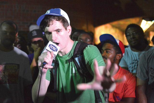 Anderson Burrus, a senior studying mass media communication, performs a freestyle rap in front of the Free Expression Tunnel during the NC State Cypher's 5 year anniversary on Monday night. Burrus has been rapping for 7 years, and he discovered the Cypher 3 years ago. He said, "The Cypher is a demonstration of what hip hop is designed to be. It's a safe environment where anyone is allowed to express themselves in any way they want. That's the side of hip hop very few people see anymore, and it's the image we try to promote every Monday night."