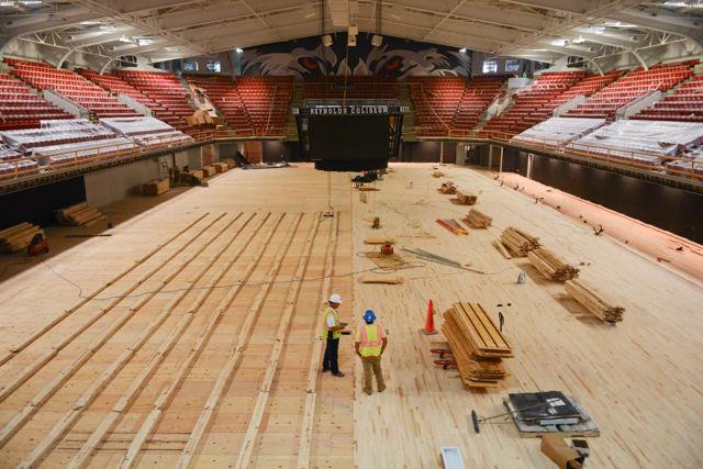 Stacks of wood slats wait to be installed in Reynolds Coliseum on June 17, 2016. The renovation project is scheduled to be completed by August with new wider stadium seating already installed in some areas, a new jumbotron installed, a new wolf eyes mural installed above the student section, air conditioning among other improvements.