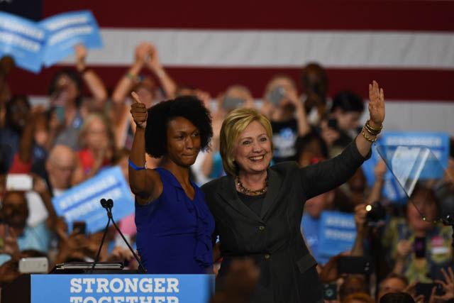 Alicia Wilkerson, Durham public school teacher, shares a moment with presidential candidate Hillary Clinton after delivering her introduction in North Carolina State Fairgrounds Exposition Center on Wednesday June 22.
