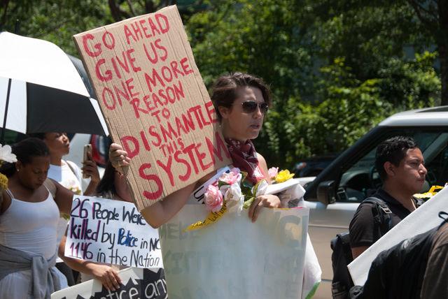Jo Nopper, one of the protesters and a member of Democracy Spring, marches to deliver the anti-HB 972 petition to Gov. Pat McCrory. The Southeast Asian Coalition spearheaded the protest effort, but other organizations including Black Lives Matter, Seeking Justice Coalition and the Queer People of Color Collective also participated.