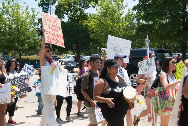 Protesters march from the Executive Mission down Jones Street while carrying signs and chanting. They delivered a petition to the Governor's office in the Administration Building demanding the veto of HB 972.
