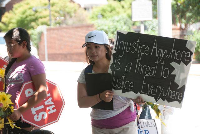 Kao Cheng Lao, a statewide basebuilding organizer for the Southeast Asian Coalition, looks on while protesters speak in front of the Executive Mansion. SEAC worked with 18 Million Rising and the American Civil Liberties Union worked together to gather over 3000 signatures on a petition urging Gov. Pat McCrory to demand the veto of HB 972.