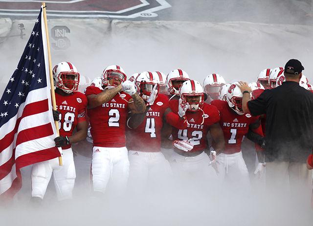 NC State&#8217;s football team enters Carter-Finley Stadium during the home opener in front of 57,451 cheering fans against Troy on Sept. 5. The Wolfpack defeated Troy 49-21 to kick off the football season.&#160;