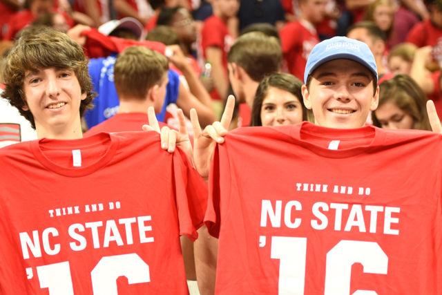 Pierce Strayer, a freshman majoring in exploratory studies, and Hanson Lucas, a freshman studying English, hold up their NC State class of 2020 shirts at the conclusion of Convocation on August 15, 2016. These two students and the rest of their peers left PNC Arena after taking a photo in their new shirts.