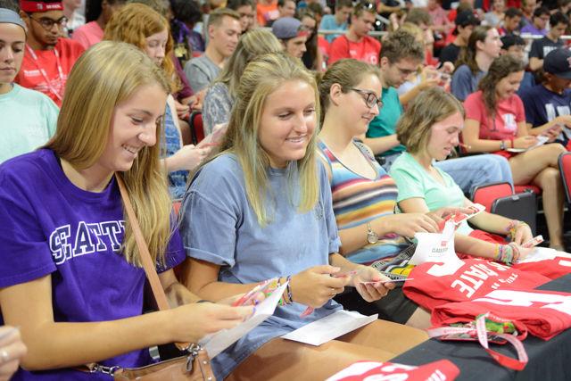 Laurel McCarthy, a freshman studying math education opens the class of 2020 envelope given to them at Convocation on Aug. 15, 2016 at PNC Arena. Students listened to Chancellor Woodson as he spoke about the importance of taking their future seriously as they discover a tassel in the envelope.