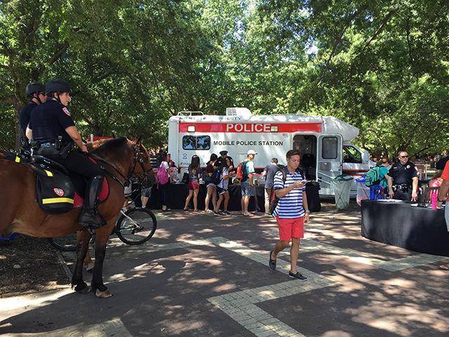 NC State University Police officers serve hot dogs and drinks at an outreach event hosted on the Brickyard on Wednesday afternoon.