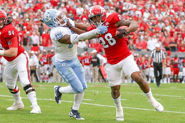 Sophomore tight end Jaylen Samuels stiff arms a UNC-Chapel Hill defender in the first half. Samuels finished with three carries for 6 yards and six receptions for 97 yards. The Wolfpack fell to the Tar Heels in the last home game of the season, 45-34, at Carter-Finley Stadium on Nov. 28.