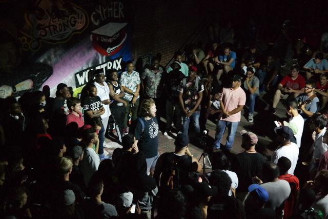 A freestyler performs in a circle of students attending Cypher in front of the Free Expression Tunnel on Aug. 22. Cypher just entered its sixth year, and was recently recognized by NC State as a student organization. Cypher gives students the chance to freestyle on topics that range from social justice issues to their opinions on music artists.
