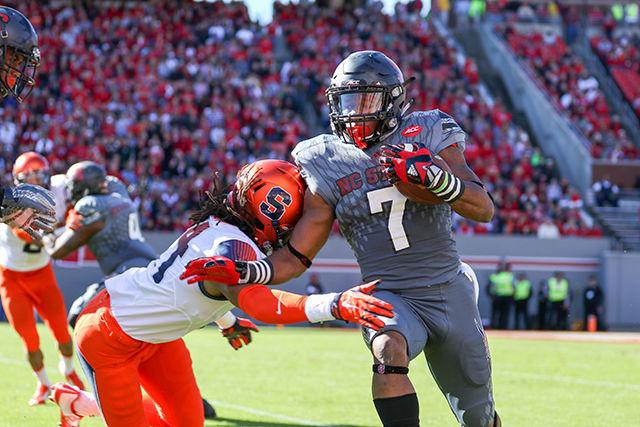 Freshman wide receiver Nyheim Hines sprints to the sideline on a kick return, stiff-arming a Syracuse defender in the process. The NC State Wolfpack beat the Syracuse Orange 42-29 at Carter-Finley Stadium on Nov. 22, 2015 to go to a record of 7-4 with a conference record of 3-4.