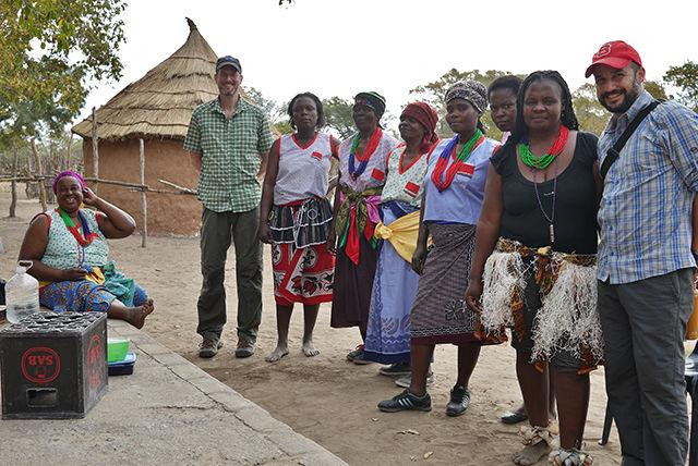 John Bass and Duarte Morais of People-First Tourism pose alongside microentreprenuers of a South African village while conducting fieldwork. People-First Tourism connects tourists with locals through an online marketplace.&#160;