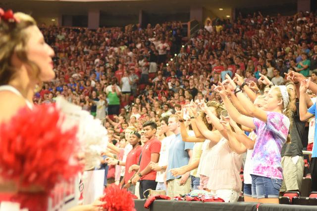 NC State freshman hold up the wolfie at PNC Arena for Convocation. The crowd of students were led in excitement by the cheerleaders and marching band of NC State.
