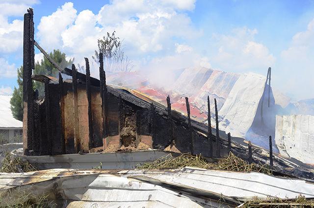 A poultry compost barn smolders after being burned to ground on Aug. 15. The fire was reported by a driver passing by the farm at 2 a.m. that morning.
&#160;